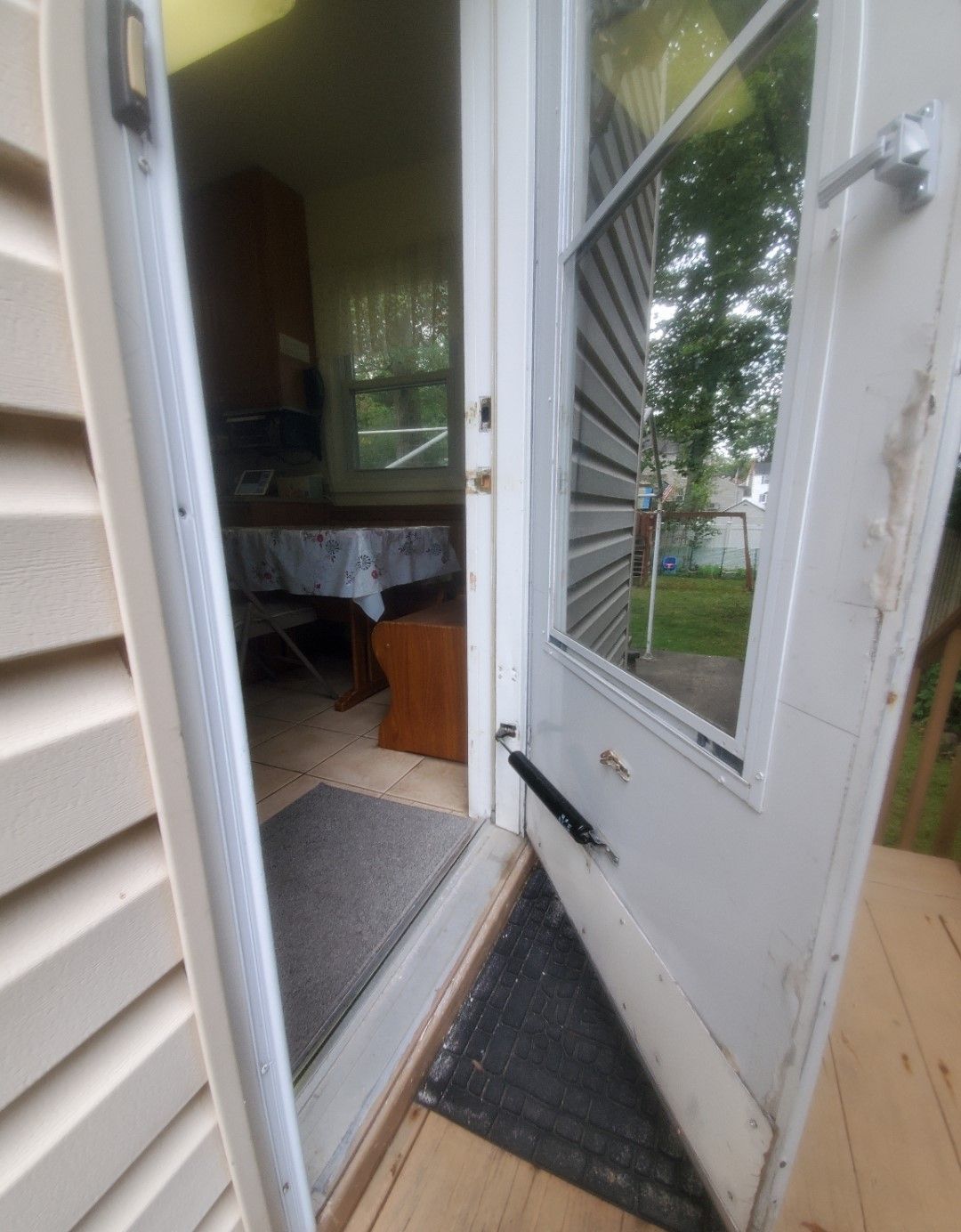 A white door is open to a room with a table and chairs