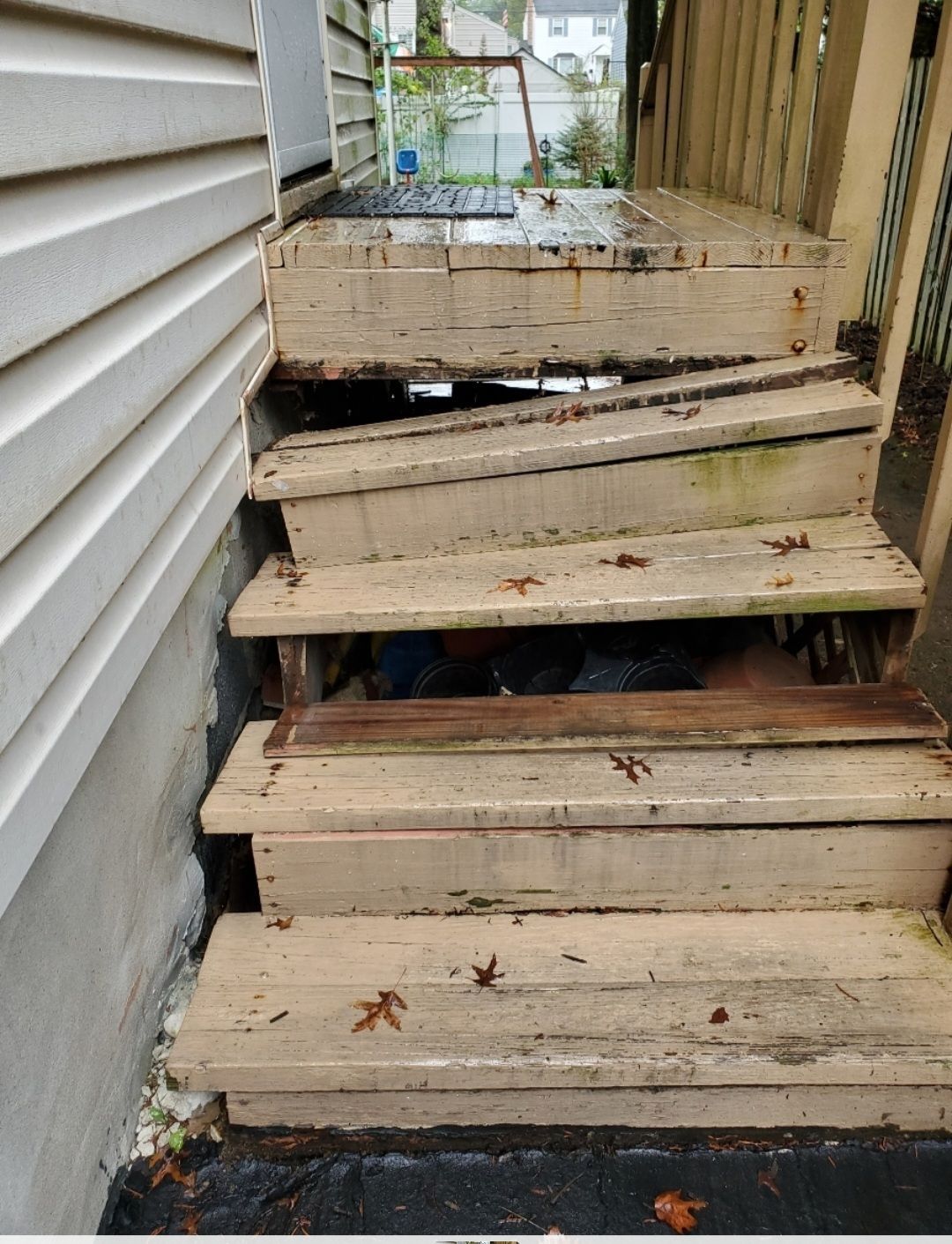 A set of wooden stairs leading up to a house
