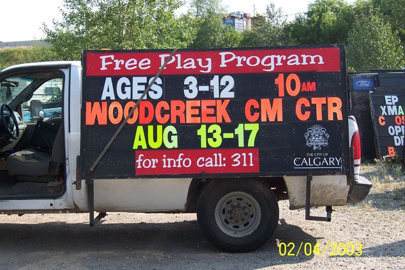 A sign on the side of a truck advertises a free play program