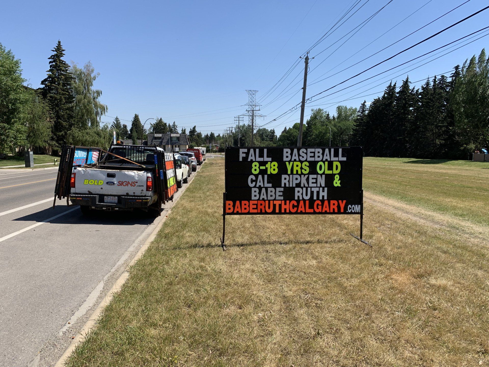 A sign on the side of the road says fall baseball