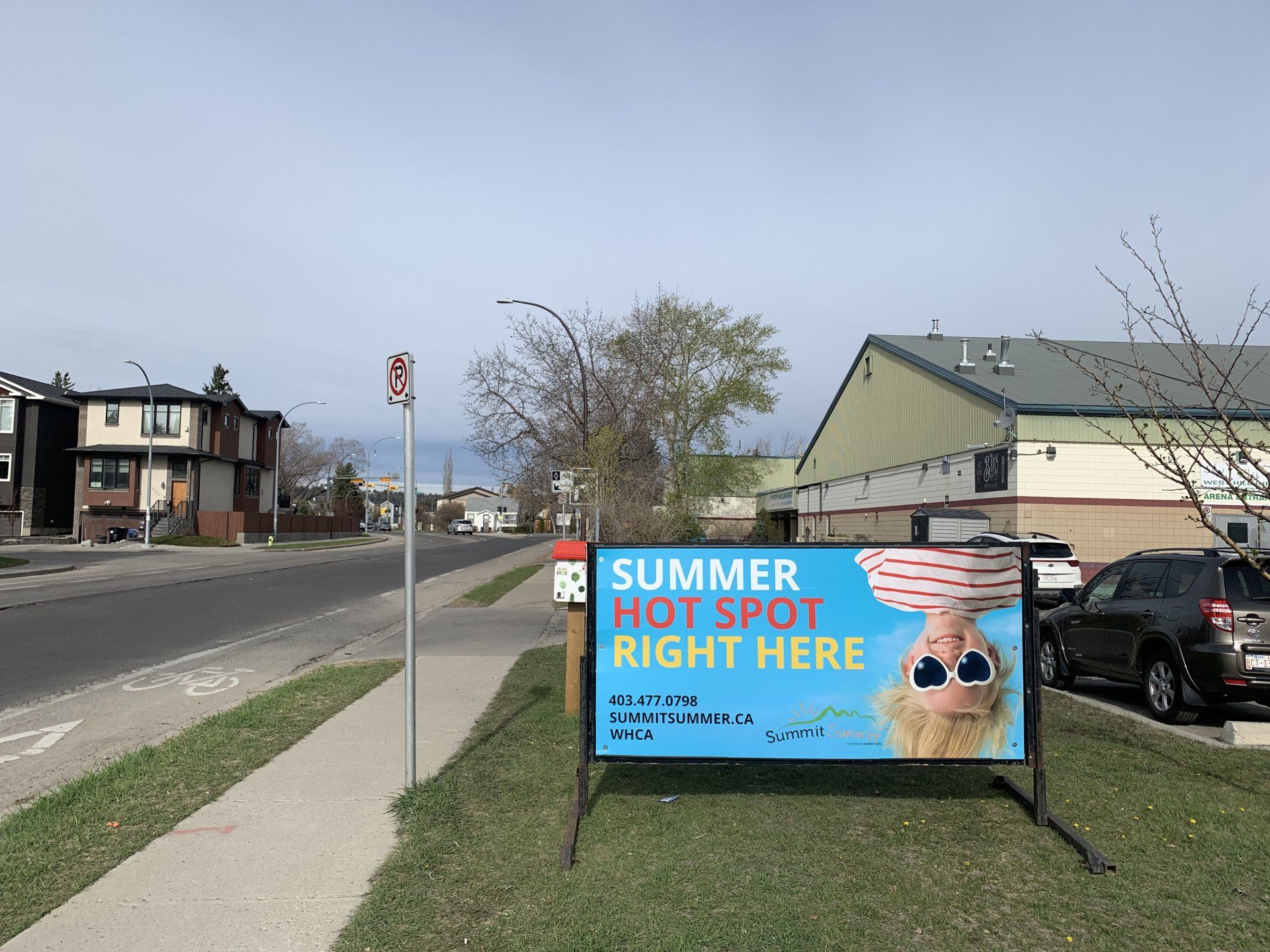 A sign on the side of the road says summer hot spot right here