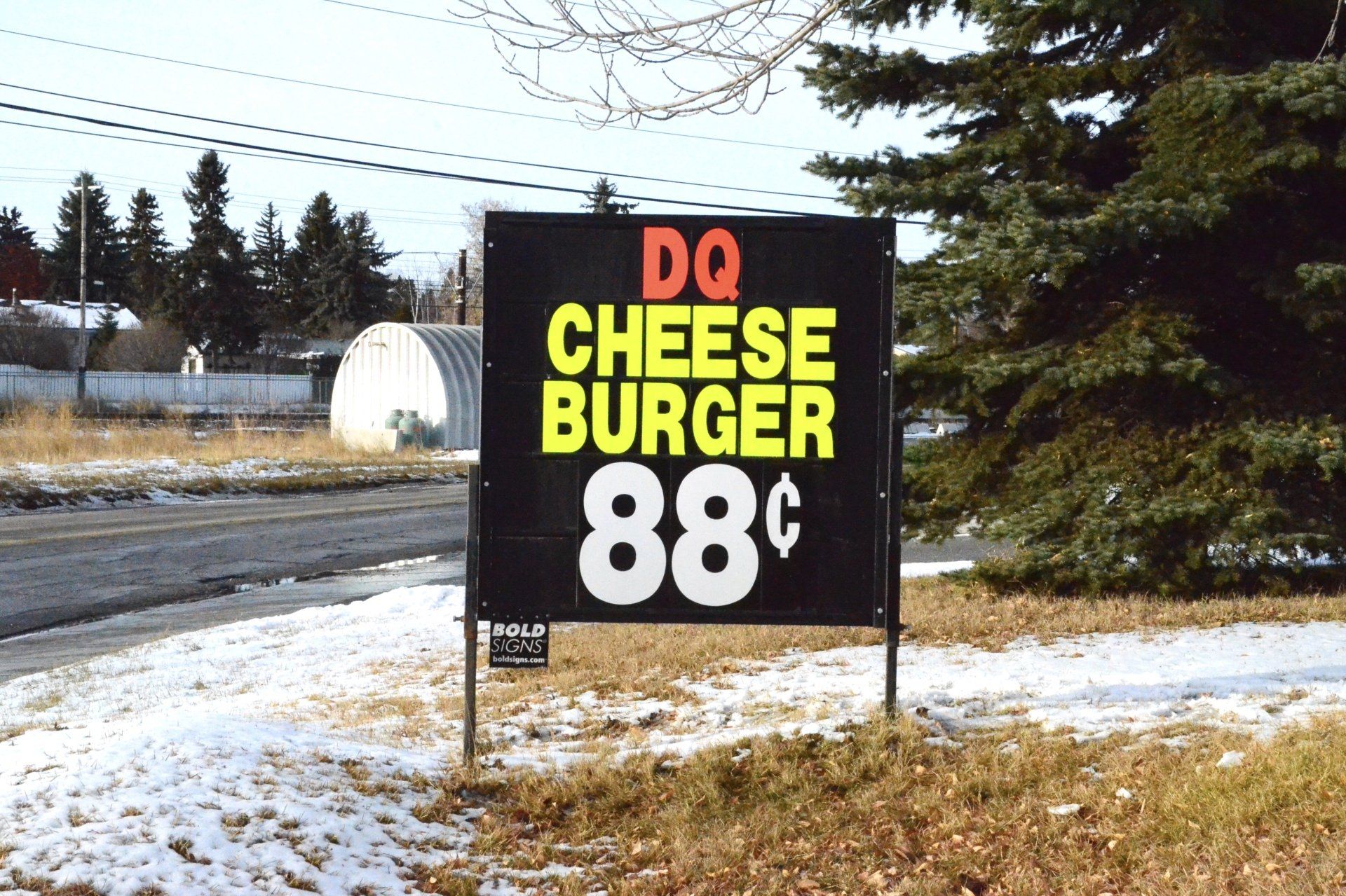 A sign that says dq cheese burger 88 cents