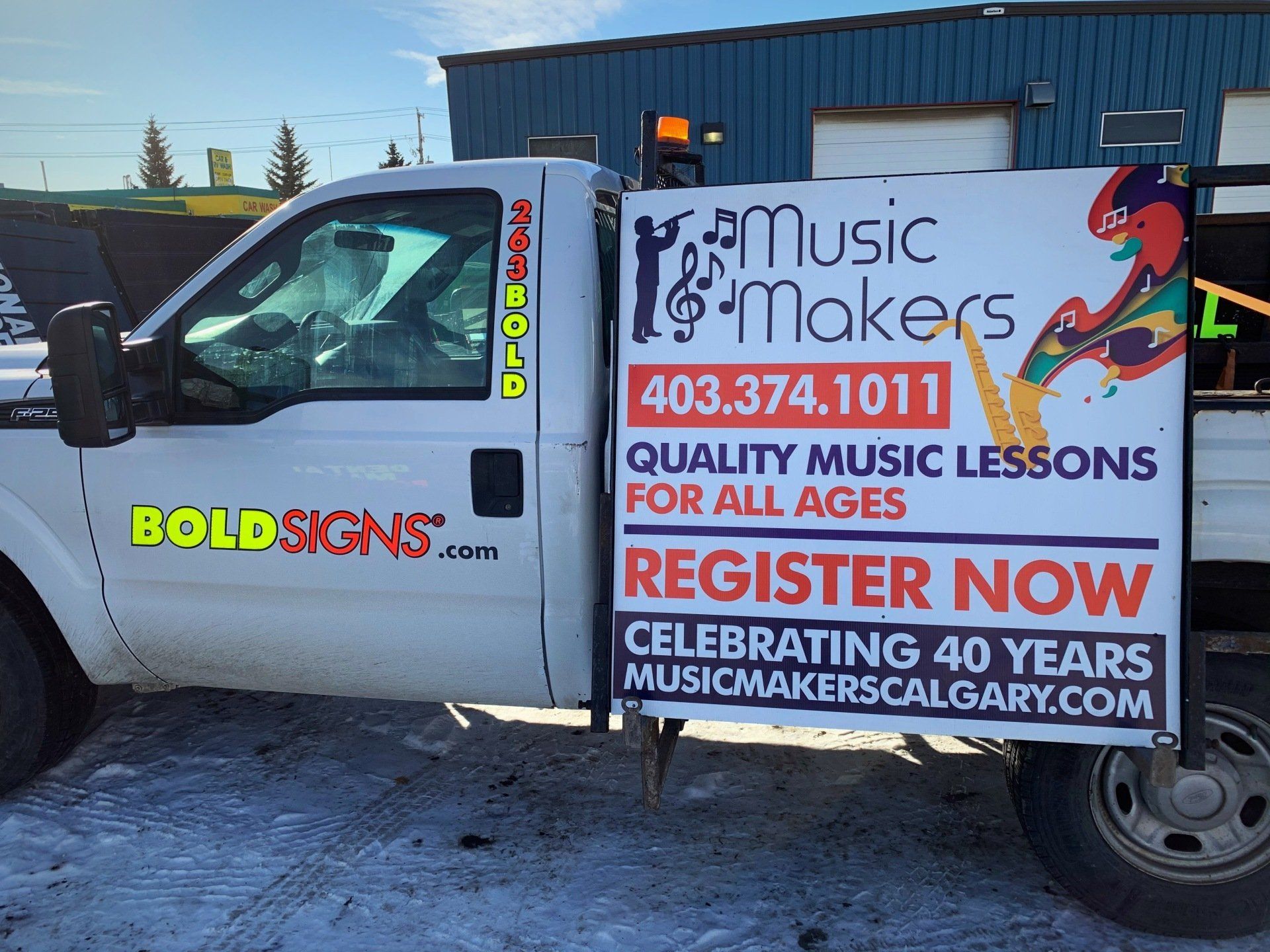 A truck with a sign on the side that says music makers