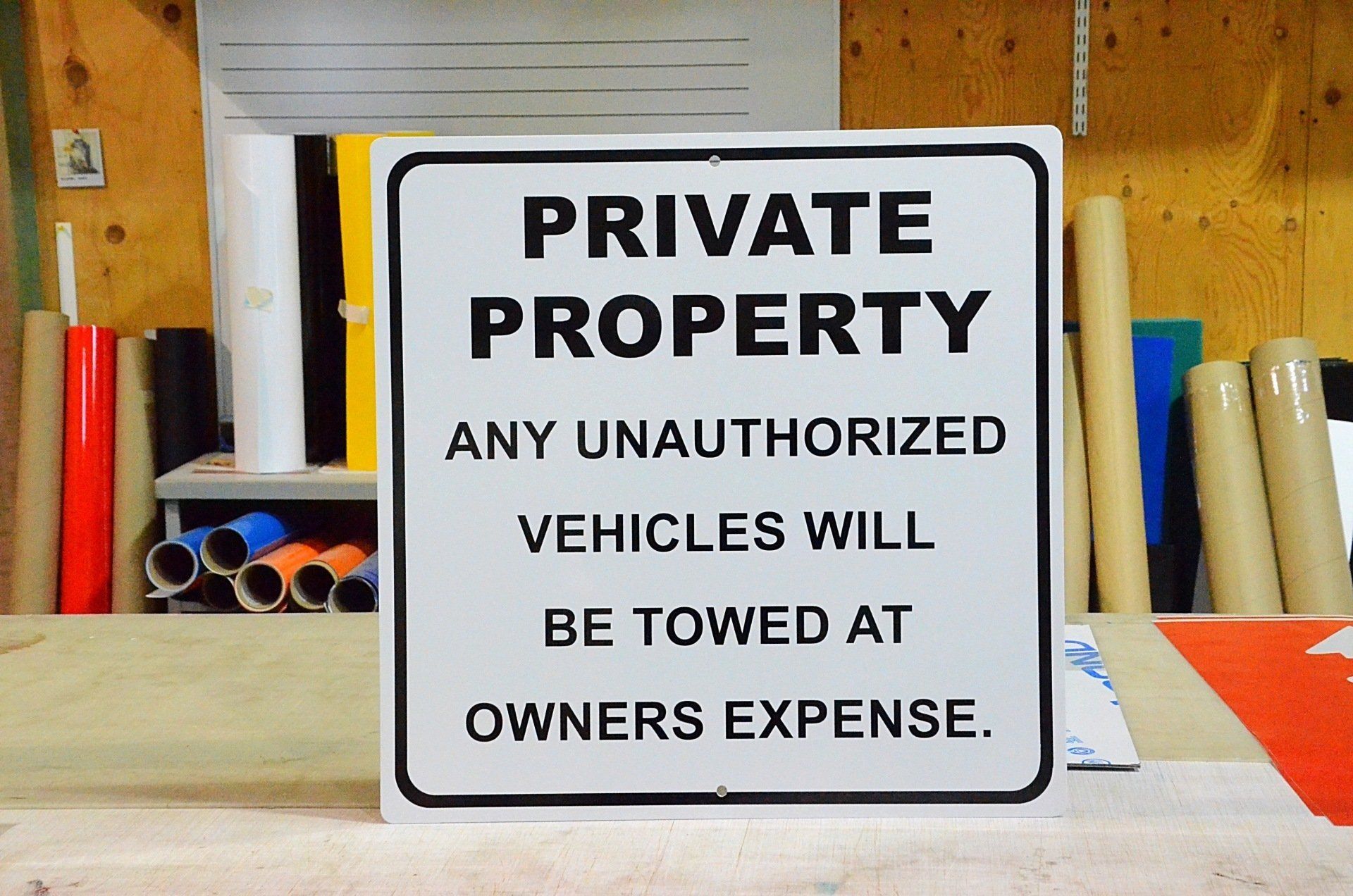 A sign that says private property any unauthorized vehicles will be towed at owners expense