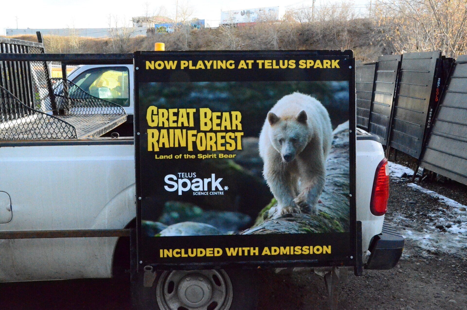 A white truck with a sign on the back that says great bear rainforest