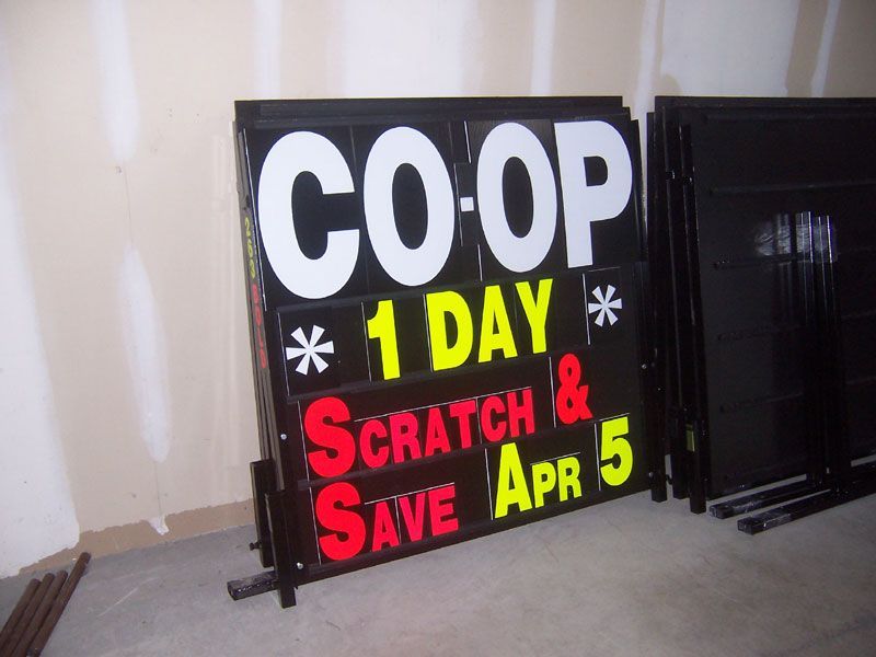 A sign that says co-op 1 day scratch and save apr 5