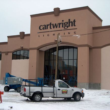 A truck is parked in front of cartwright lighting