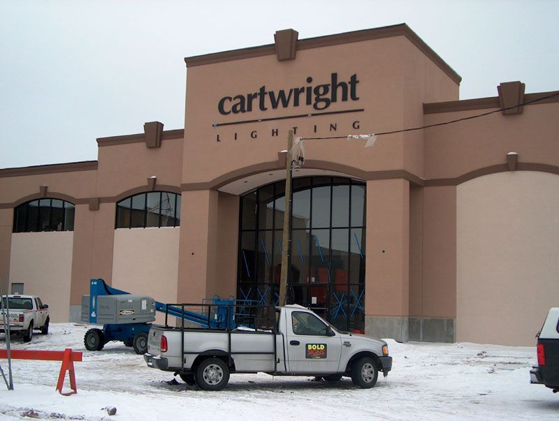A truck is parked in front of a cartwright building