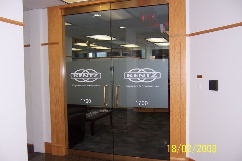 A glass door with a kentz logo on it