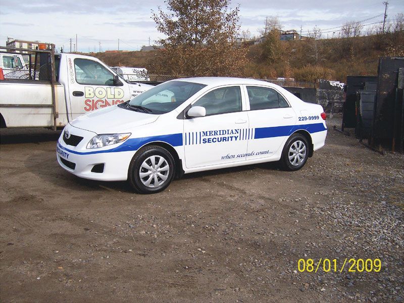 A white and blue car with williams security written on the side