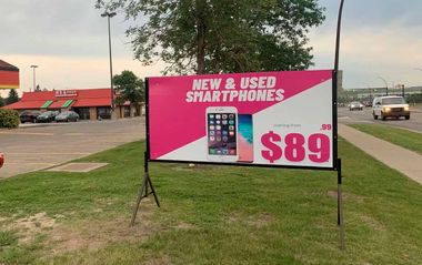 A billboard advertising new and used smartphones for $ 89