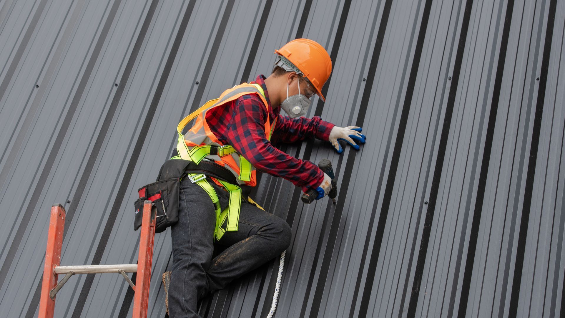 An image of roofing contractor adding metal roof to a local house in Royal Palm Beach FL