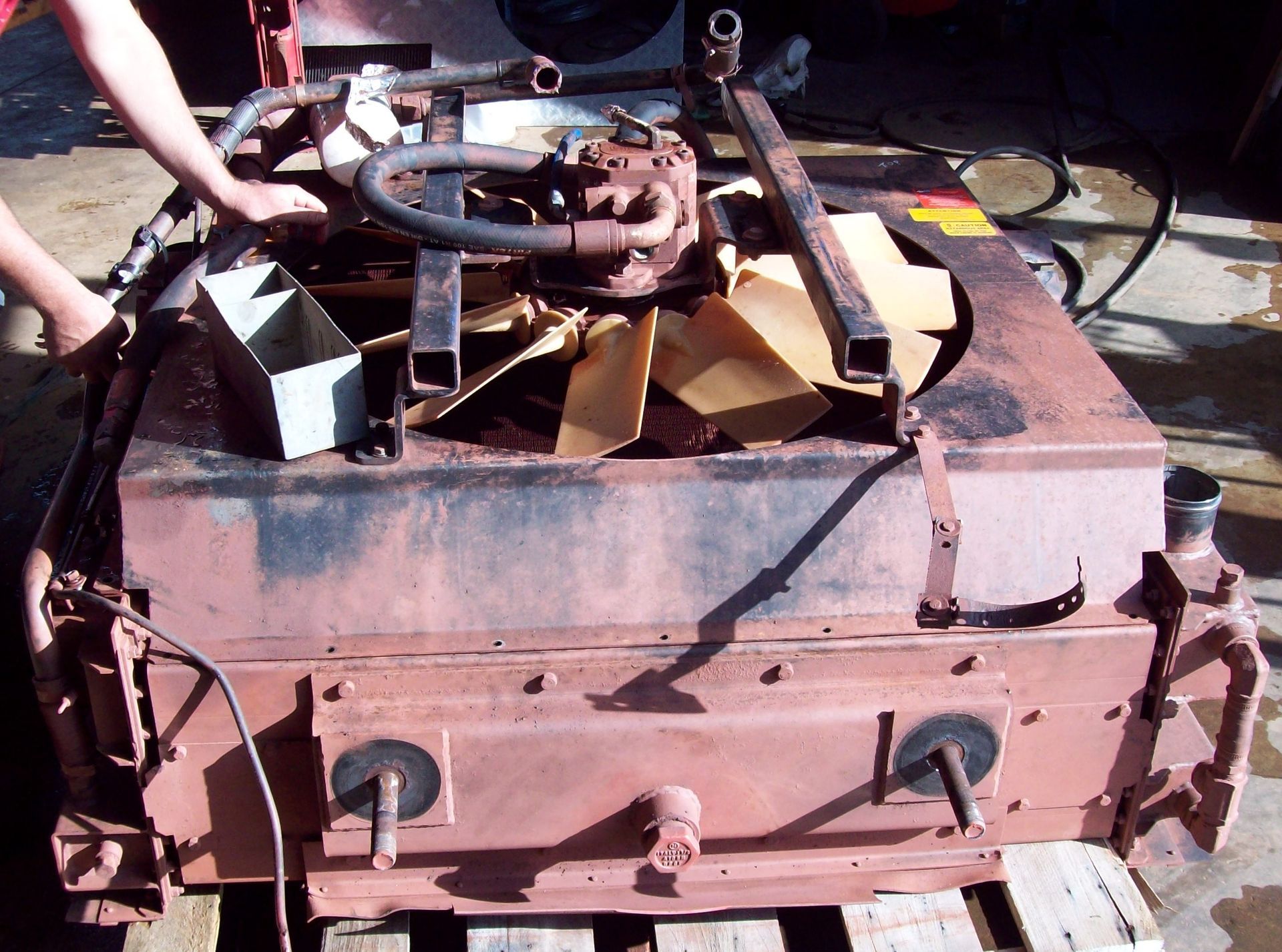 A Man is Fixing a Radiator — Berrimah Radiator Service In Berrimah, NT