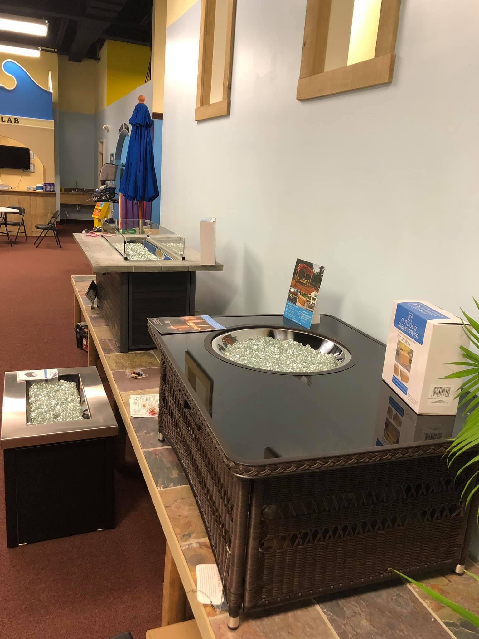 Outdoor fire pit displays in a showroom setting.