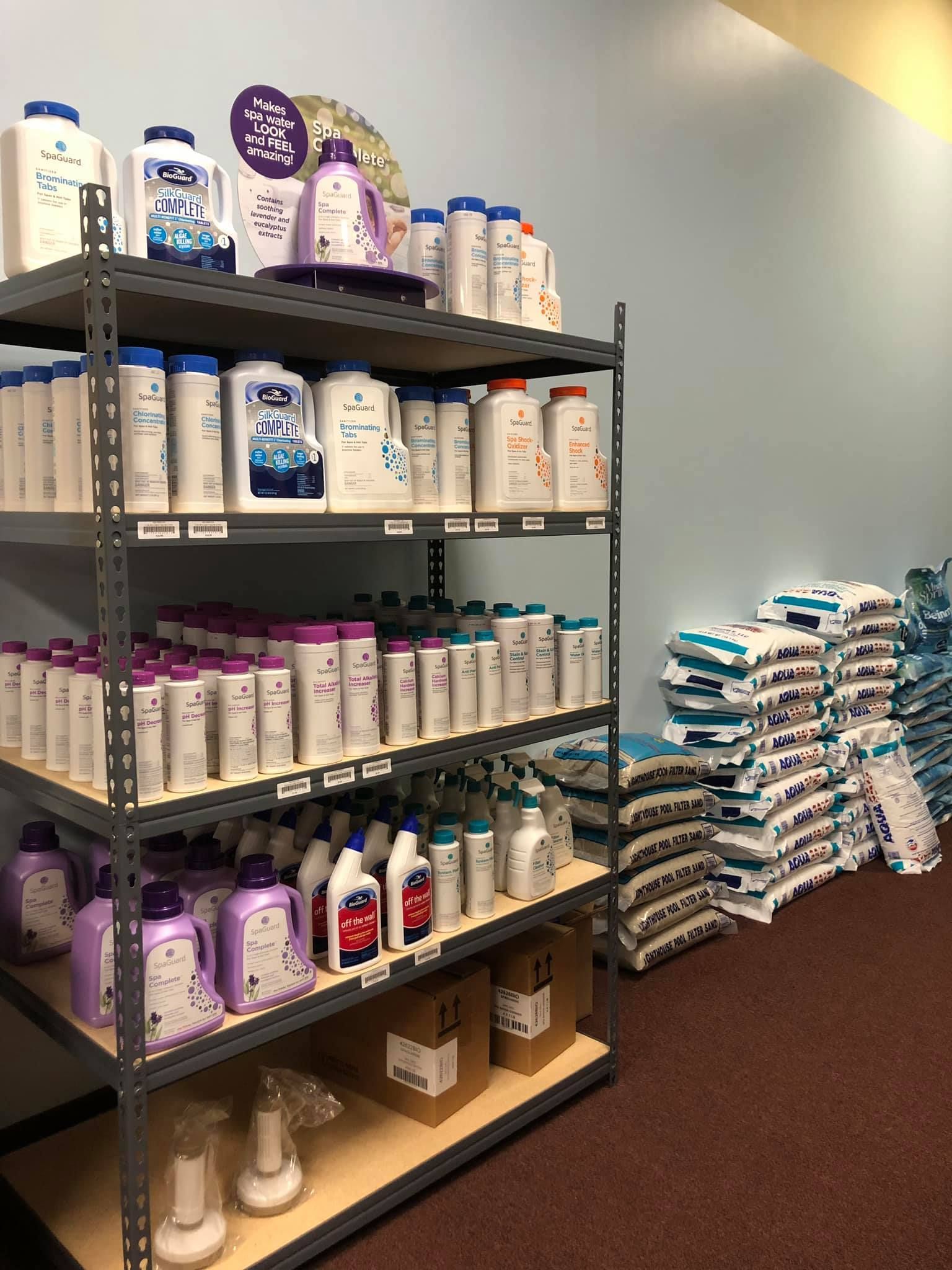 Shelves stocked with various laundry and cleaning products, next to stacked bags.