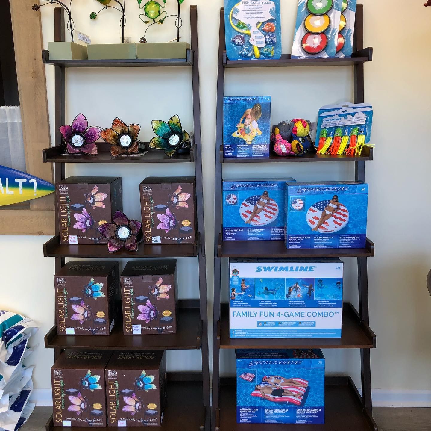 Shelves displaying various pool floats and water toys in a store.