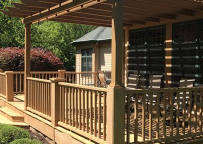 A wooden deck with a pergola on top of it