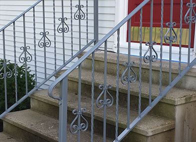 A set of stairs with a wrought iron railing