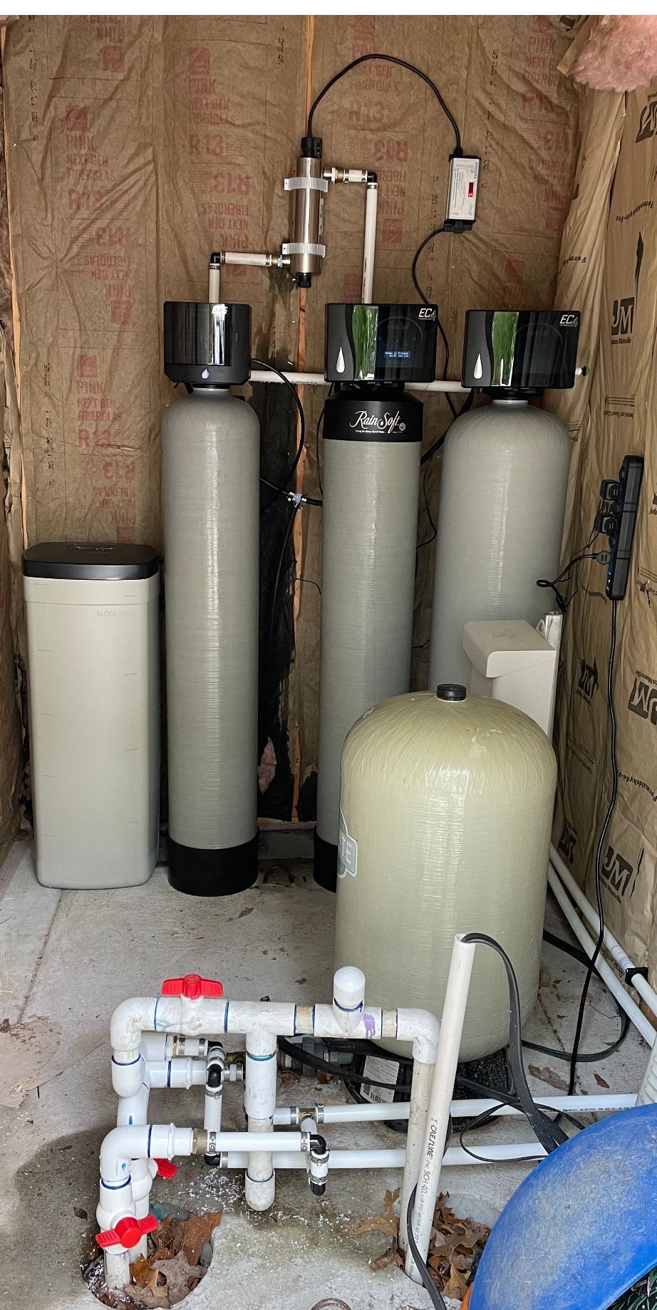 A room filled with lots of blue water filtration equipment