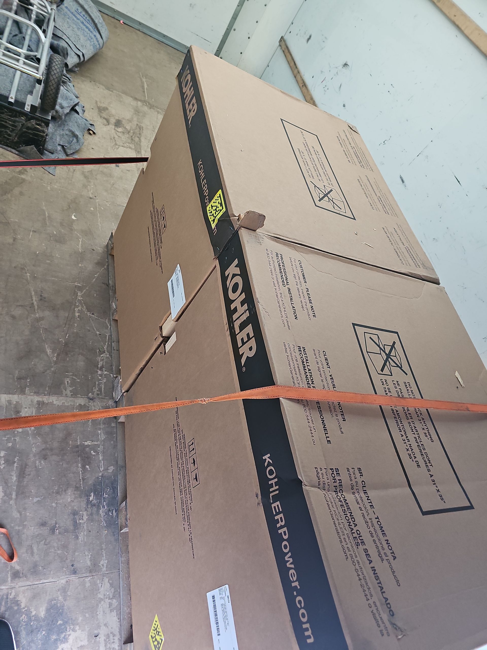 A large cardboard box that says ' kohler ' on it