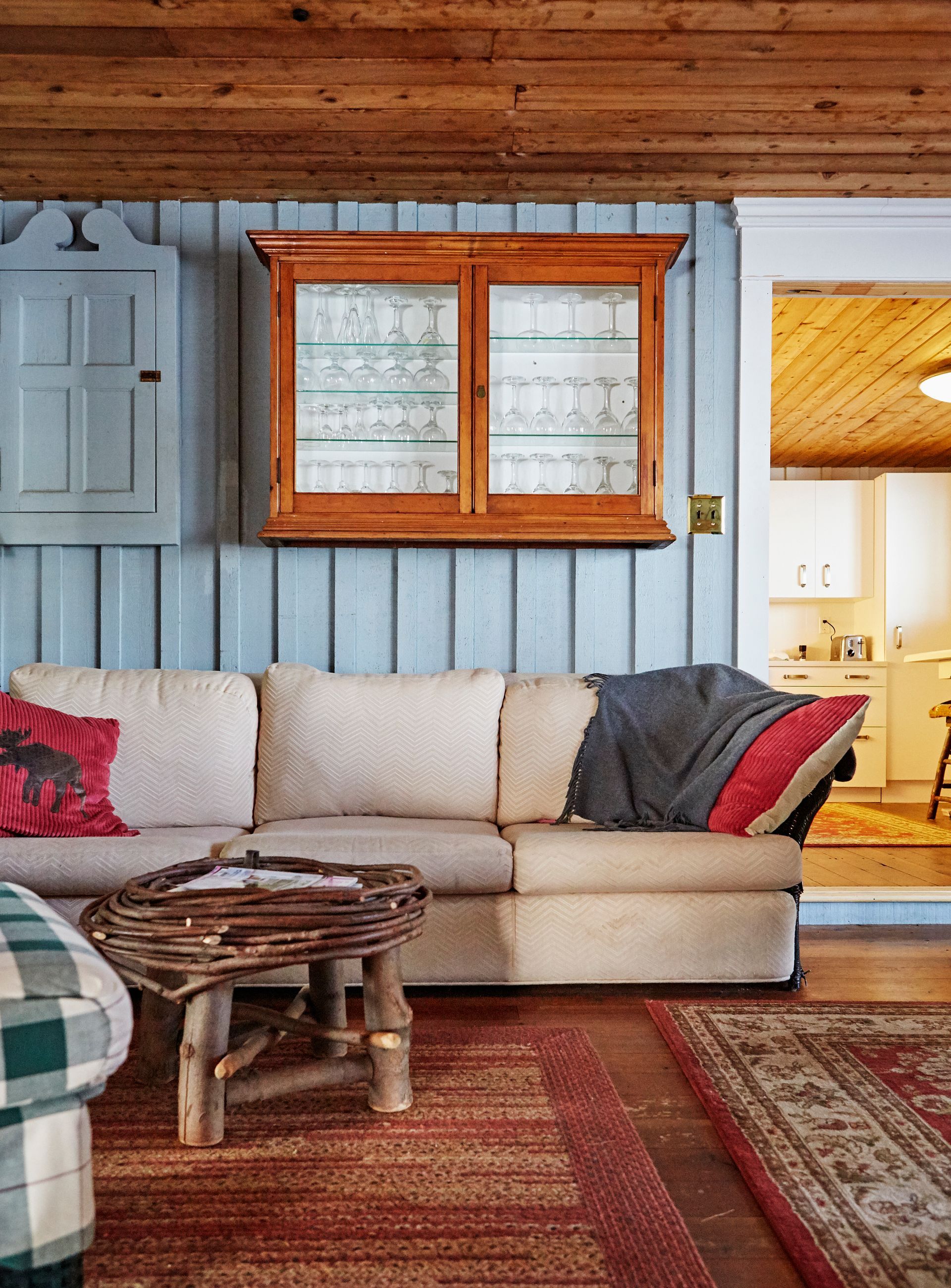 A living room with a couch and a wicker table