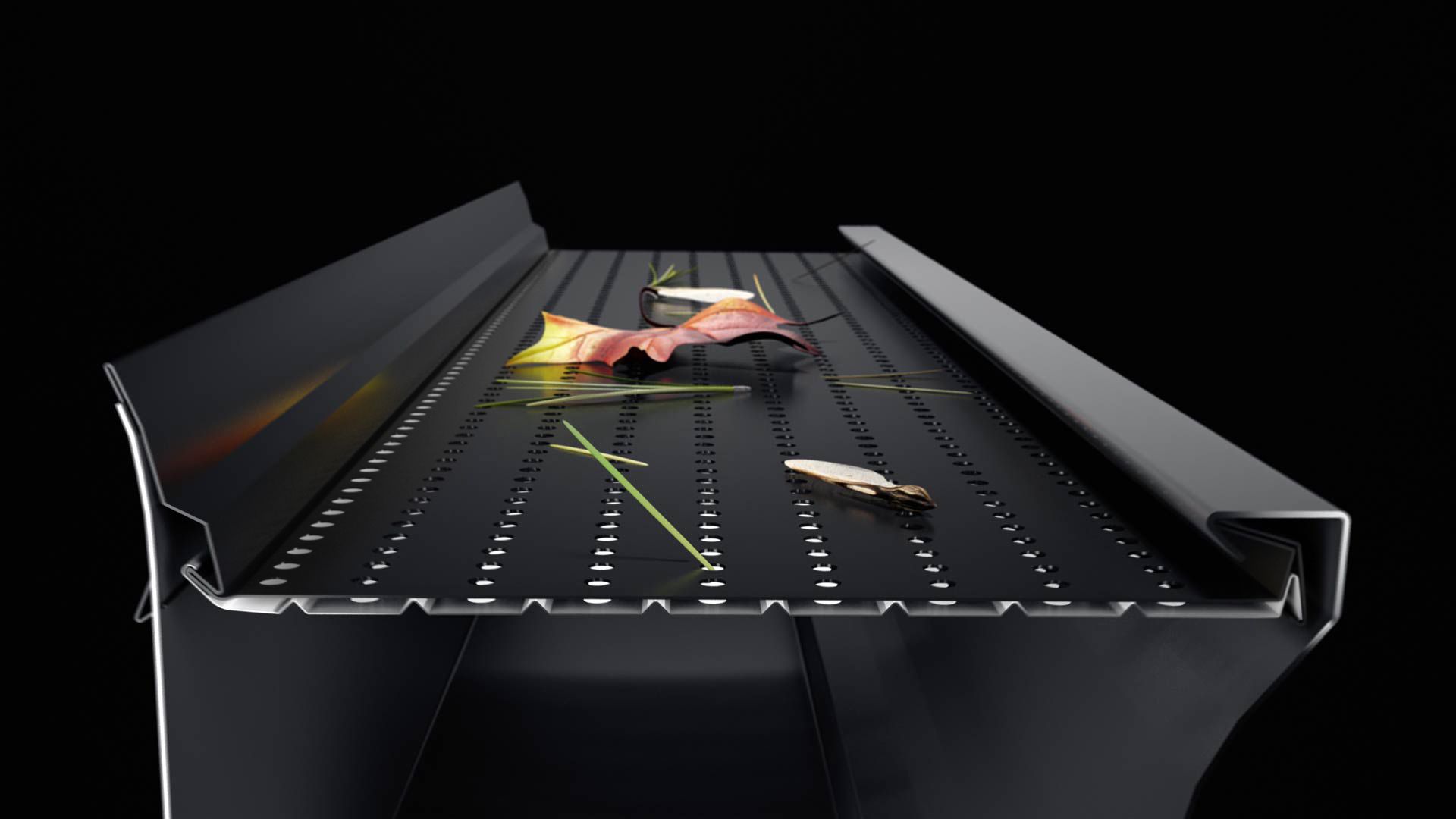 Coupe transversale d'un système de gouttière noire avec un filtre pare-feuilles métallique perforé sur le dessus