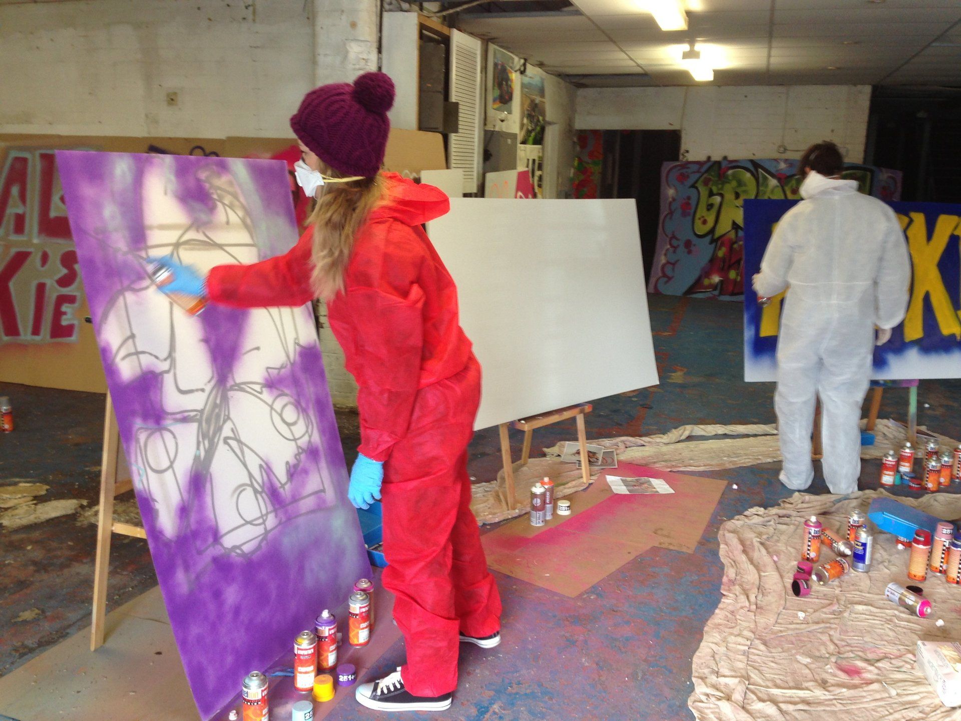 Young lady painting at a Graffiti Workshop