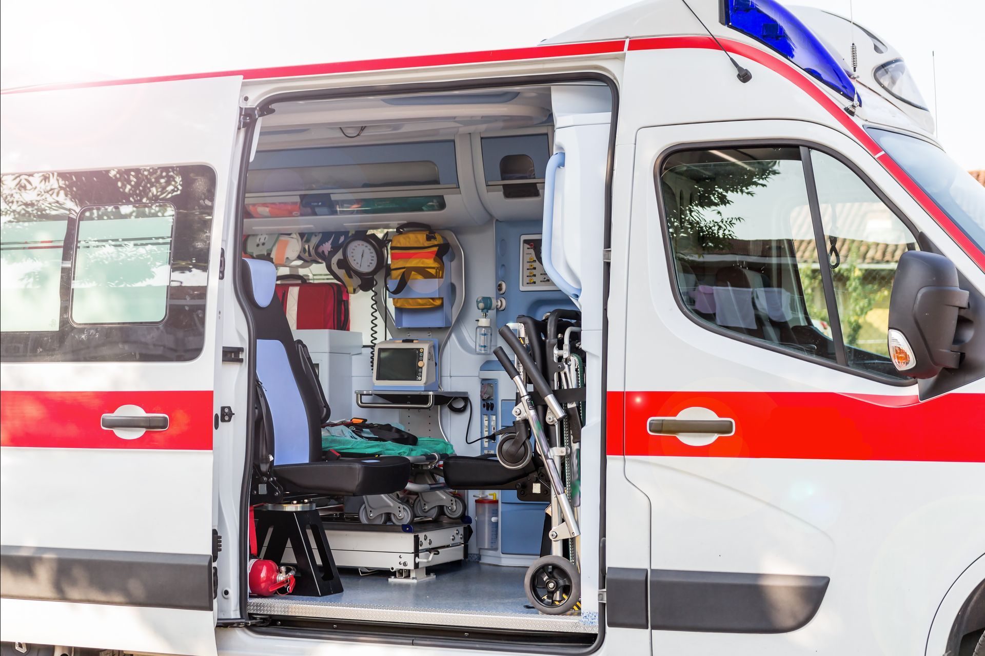Open ambulance with stretcher and medical equipment visible inside