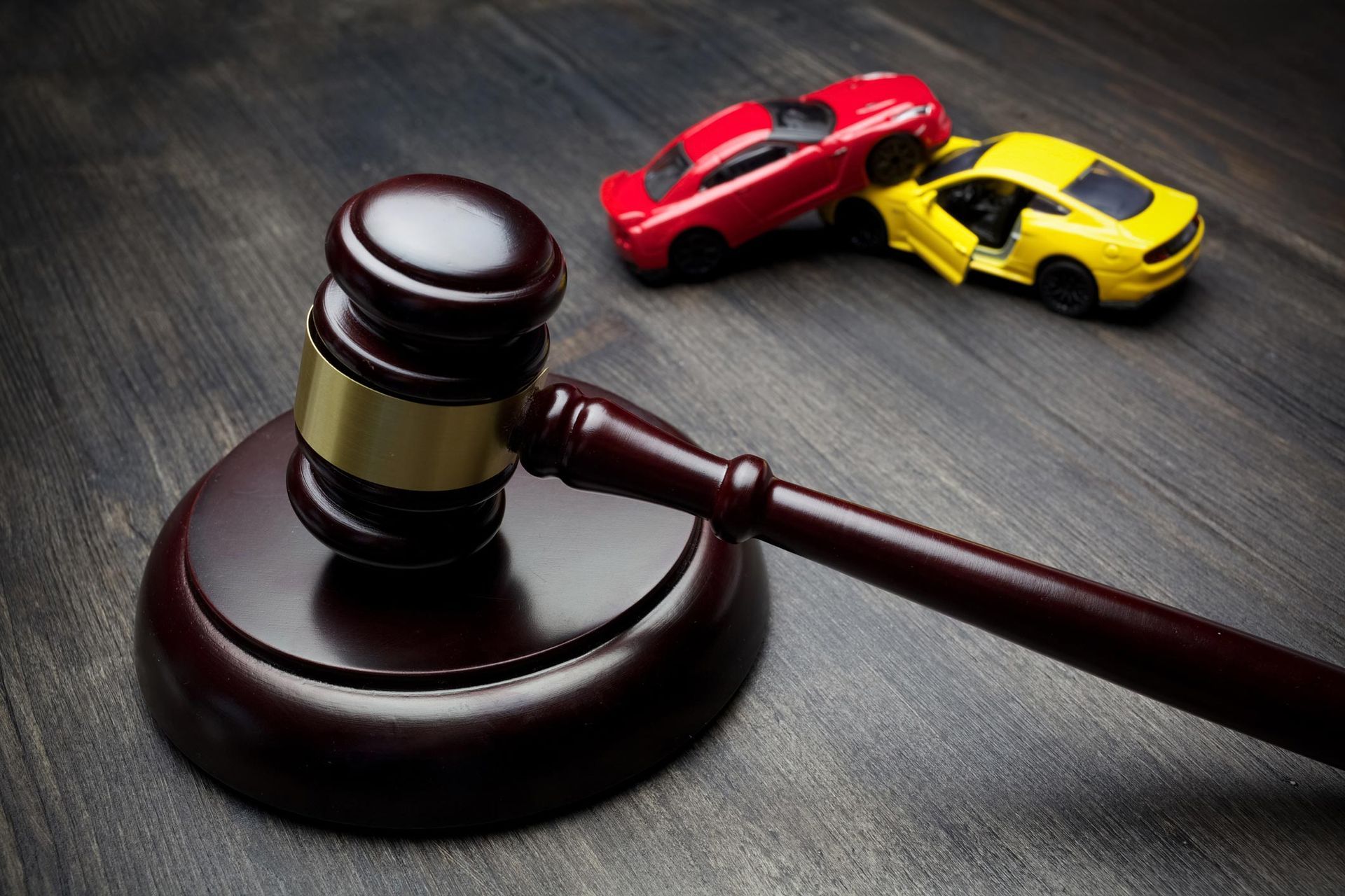 A gavel and damaged cars after a collision representing Paul R. Bennett, Car Accident Attorney in Co