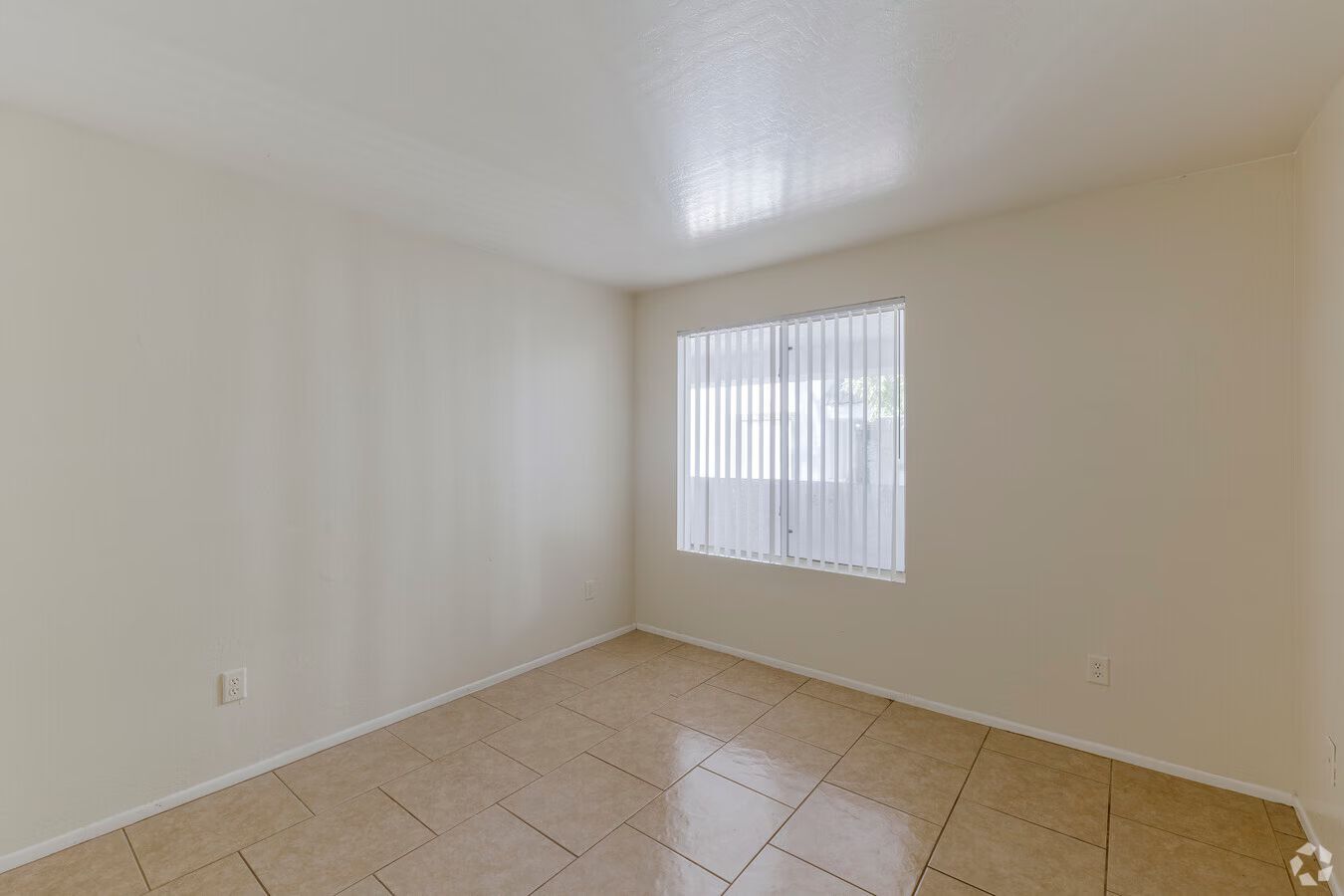 Photo of a room with tile flooring and plenty of natural lighting