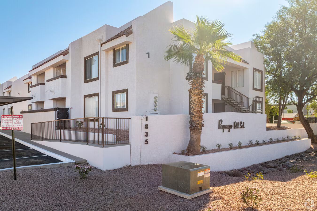Photo of a building with a ramp approaching the building and a few trees throughout