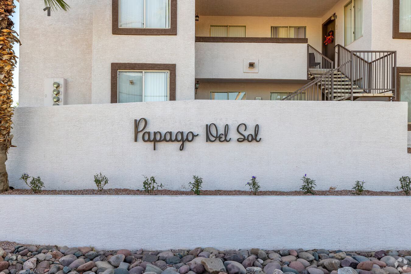 Photo of the apartment entrance, showing the community sign saying 