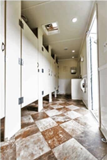 Inside view of Extraordinaire 10 Stall Restroom Trailer — Toilets Rental in Clarksville, NY