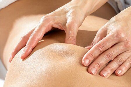 Deep Tissue Massage — Hands Massaging A Woman in Palm Desert, CA
