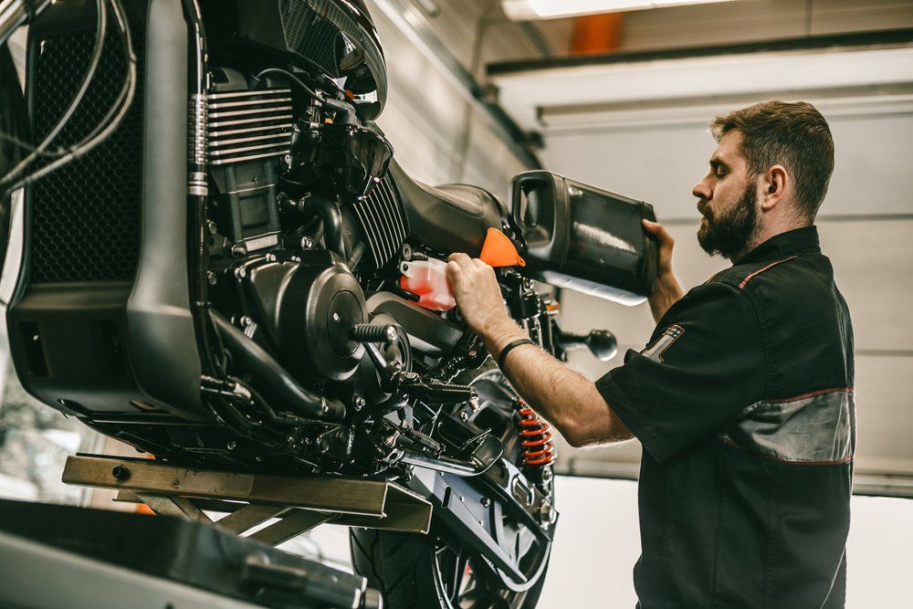 Mechanic replacing and pouring fresh oil into engine — Auto Electrician Near Me in Palmerston NT