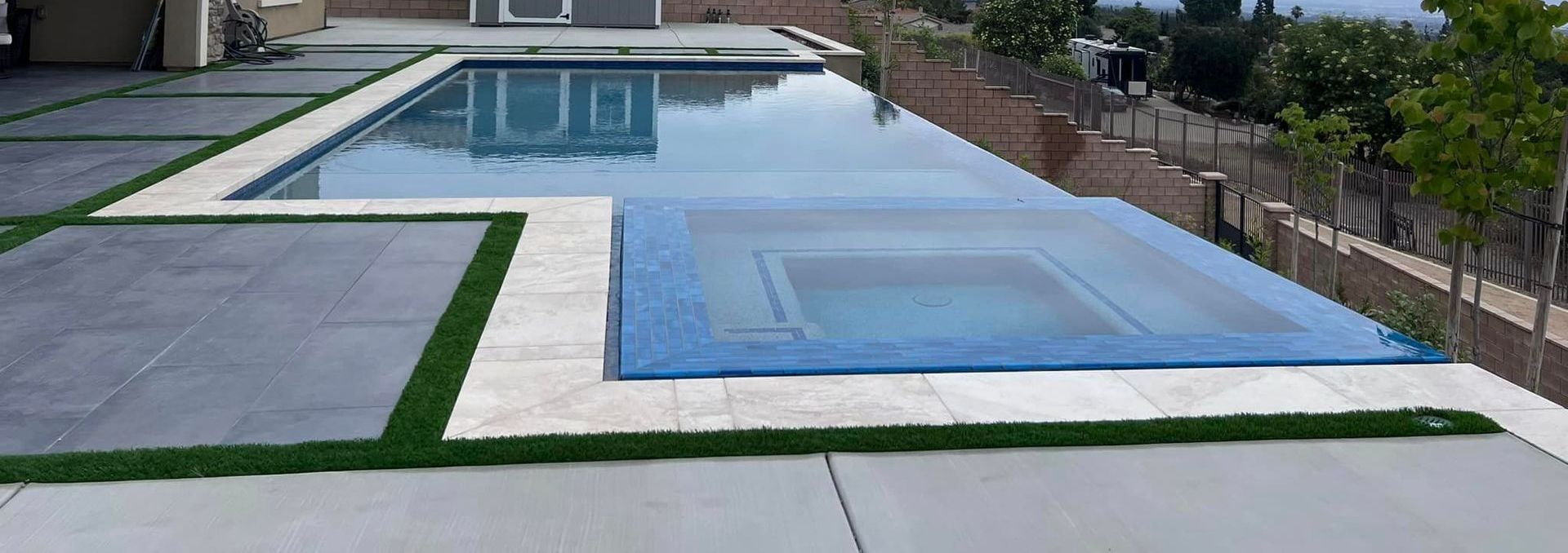 A large swimming pool with a blue cover on it.