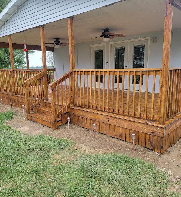 A white house with a wooden porch and stairs