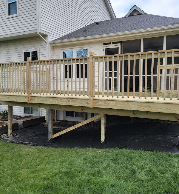 A wooden deck is sitting in front of a house.