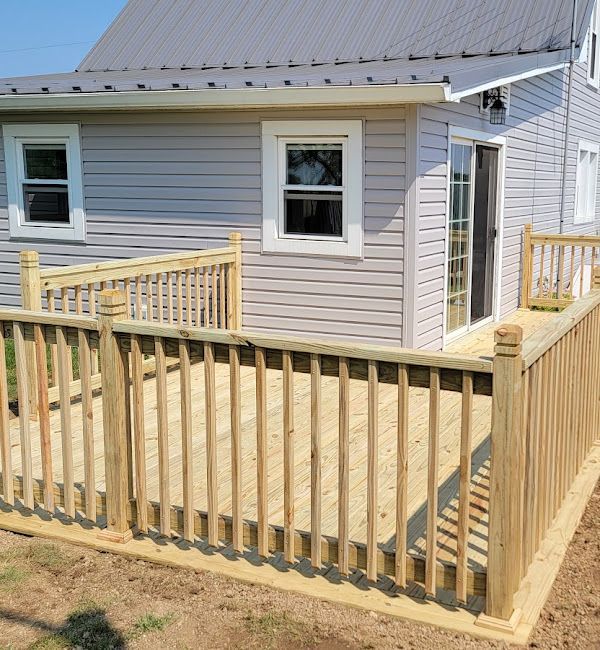 A house with a wooden deck in front of it