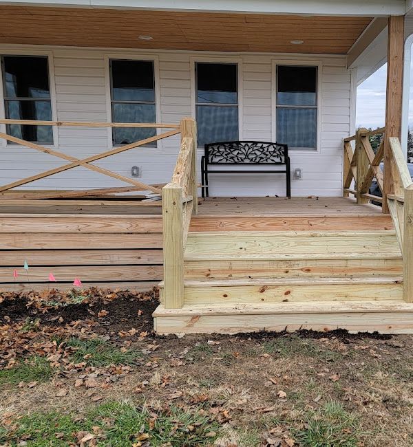 A white house with a wooden deck and stairs