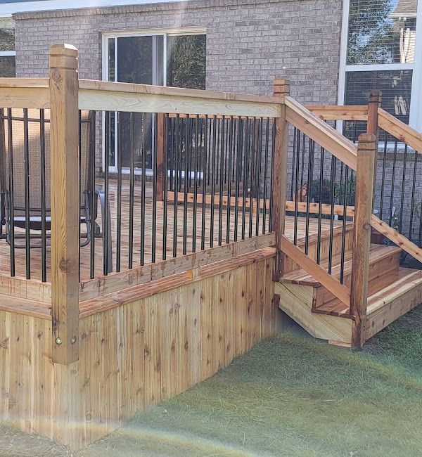 A wooden deck with stairs and a metal railing