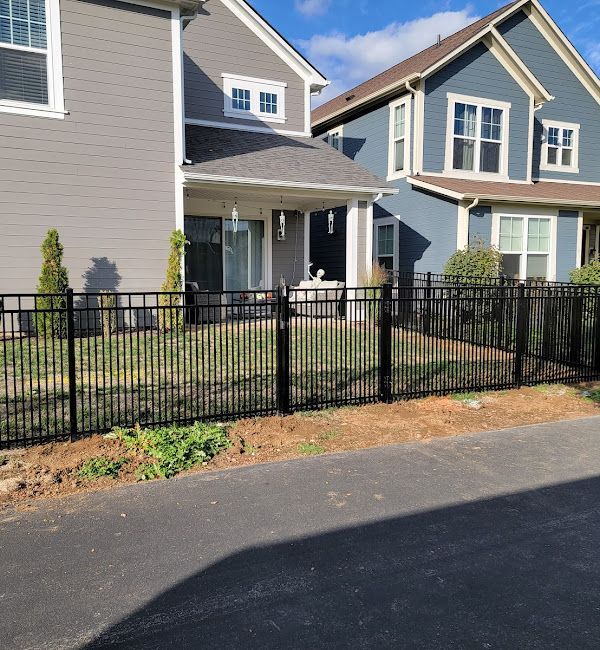 A house with a black fence in front of it