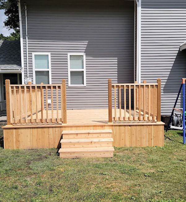 A wooden deck with stairs in front of a house