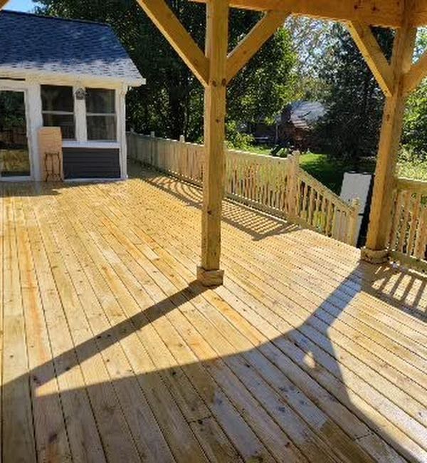 A wooden deck with a shed in the background.