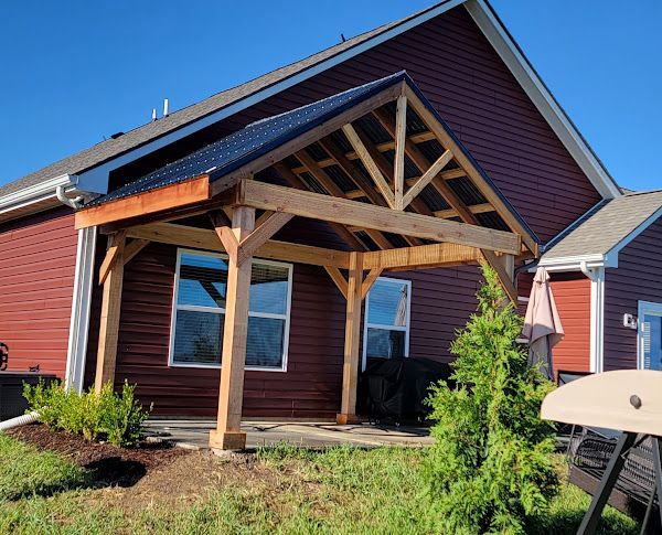 A red house with a wooden porch in front of it