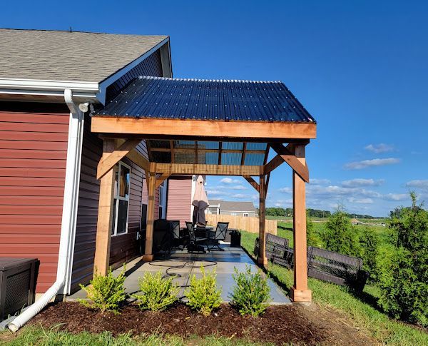 A house with a pergola on the side of it.
