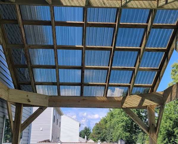 A wooden structure with a clear plastic roof.