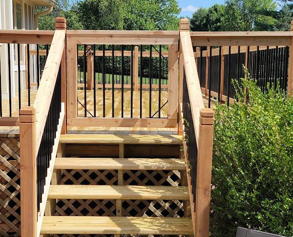 A wooden deck with stairs leading up to it