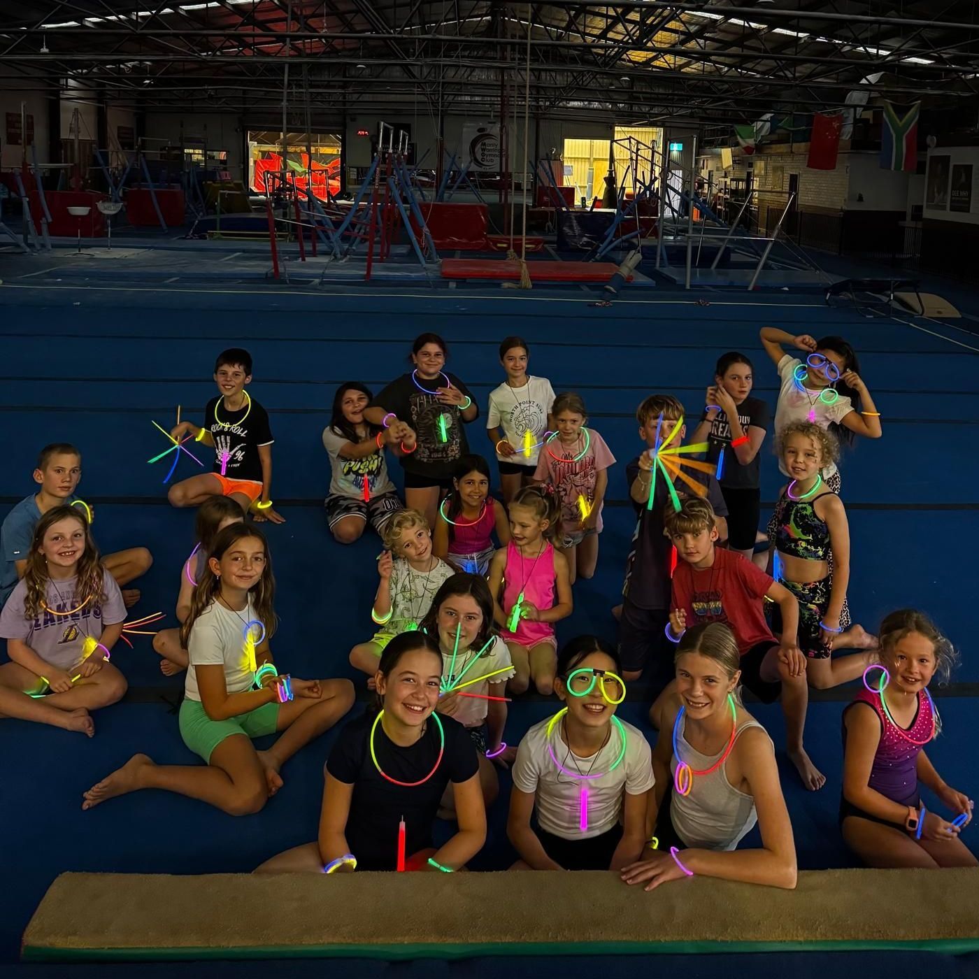 A group of children are posing for a picture in a gym