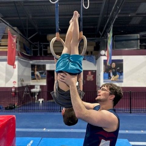 man supporting child doing flip